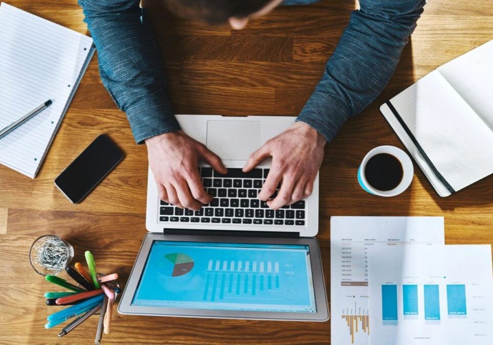 A person is using a laptop on the desk